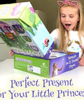 Girl excitedly opening Unicorn Fairy Garden Kit With Light Up Terrarium For Girls Ages 4 To 12 on table.