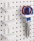 Must Have 4 Pack Pegboard Plier Holders For Pliers And Scissors Durable Plastic Double Hole Tool Hangers installed on pegboard.