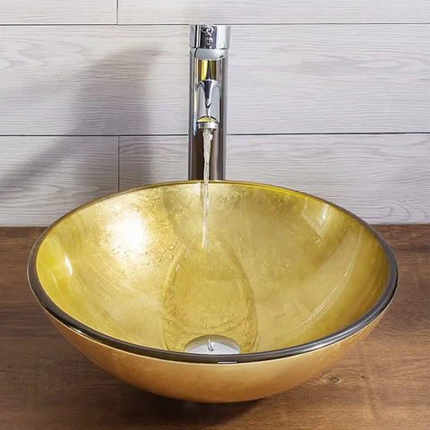 Bathroom Vessel Sink,Tempered Glass Sink Yellow Round Wash Basin Bowl with chrome faucet and water flow.