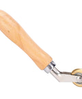 Wooden-handle seam roller with metal frame and small brass wheel for roofing membranes