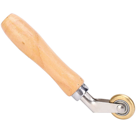 Wooden-handle seam roller with metal frame and small brass wheel for roofing membranes
