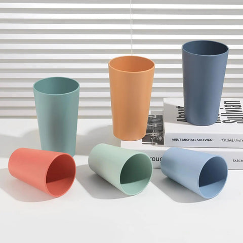 12 Piece Wheat Straw Cups Set With 6 Colorful 12 Oz Cups And 6 Colorful 20 Oz Cups Unbreakable BPA Free Reusable Plastic Drinking Cups For Outdoor Camping Kitchen Use Microwave And Dishwasher Safe Built Tough For All Your Adventures displayed on a white surface with a book in the background