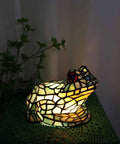 Frog Table Lamp Tiffany Style Stained Glass Accent Night Light for Home Decor, multicolor stained glass frog shining softly in dark room.