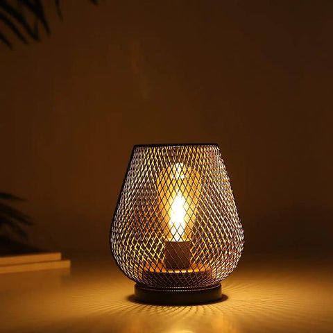 Bronze egg colored metal cage LED lantern emitting warm white glow, part of cordless Accent Light Set of 2 for cozy ambiance