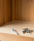Built Right 40 Piece Drawer Connector Hardware Kit With Pre Inserted Bolts And Nuts Pro Grade alloy cam bolt and screws on wooden shelf.