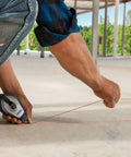 Worker using Speedline Pro Chalk Reel 100 Foot Hi Tensile Line With Easy Fill Lock Top Three To One Gear Rewind on rough surface
