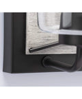 Close-up of Three-Light Coastal Bath Vanity Light with faux woodgrain backplate and graphite black finish detail.