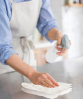 Person using Lint Free Cleaning Rags 24 Pack 100 Percent Cotton Cloths on countertop for cleaning.