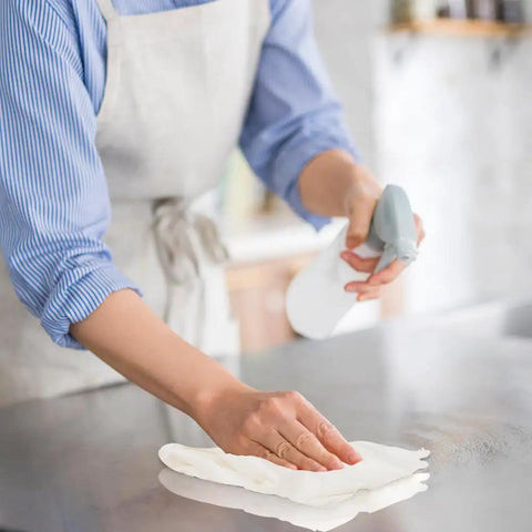 Person using Lint Free Cleaning Rags 24 Pack 100 Percent Cotton Cloths on countertop for cleaning.