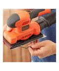 Heavy Workhorse Orbital Sander With One Third Sheet Pad And Quick Attach Clamps Cranks Out 14000 Rpm being used for sanding.