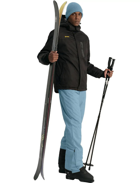 Model wearing Insulated Waterproof Ski Bib Overalls For Men, Bomber Snowboarding Pants With Warm Thick Liner, Haze Blue, Large, holding skis