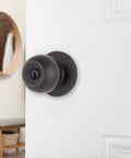 Transitional Keyed Entry Door Knob in Tuscan Bronze Exterior Lock Set Easy Install shown on white door