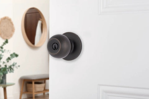 Transitional Keyed Entry Door Knob in Tuscan Bronze Exterior Lock Set Easy Install shown on white door