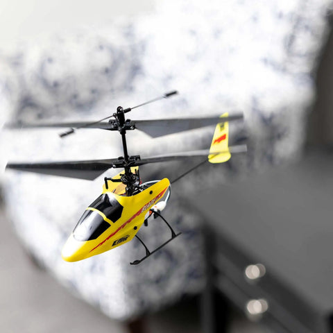 Yellow MCX Anniversary Edition RC Helicopter Ready To Fly Indoor Ultra Micro Flyer in living room, showing smooth stable flight.