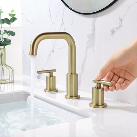 Brushed Gold 8 Inch Widespread Bathroom Faucet With Two Handles Three Hole Mount 360 Degree Swivel Spout in use at sink
