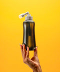 MicroJet MJ 450 Portable Bidet And Peri Bottle Sprayer For Travel, ergonomic squeeze bottle with angled nozzle, yellow background.
