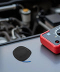 Automatic Vehicle Fire Extinguisher 30G Aerosol Suppression Kit for Cars Trucks ATVs RV placed on a vehicle engine.