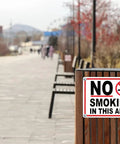 No Smoking Sign 10 x 14 Inch Aluminum No Vaping Sign 4 Pack on wood post along outdoor walkway