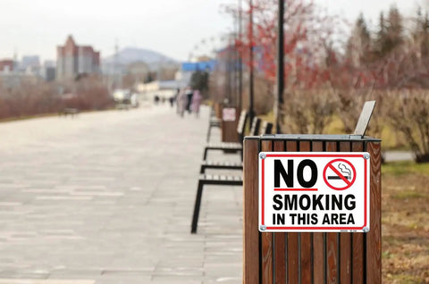 No Smoking Sign 10 x 14 Inch Aluminum No Vaping Sign 4 Pack on wood post along outdoor walkway