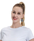 Black And White Grid Print Dangle Earrings For Women, Hella Lightweight Faux PVC Leather Look With Secure Silver Plated Hooks worn by a woman.