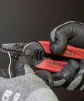Gloved hands using Made In USA Compact Wire Stripper And Cutter For 16 To 26 AWG Stranded Wire With Narrow Nose Self Opening Spring