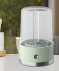 Compact Portable Washer For Delicate Laundry With Three Spin Settings Quiet Eco Friendly Design Featherweight Build Perfect For Dorm Digs Apartment Life Weekend Road Trips And Daily Freshening Up Green Finish on a table with a toothbrush in the background.