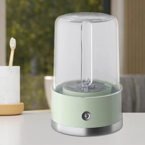 Compact Portable Washer For Delicate Laundry With Three Spin Settings Quiet Eco Friendly Design Featherweight Build Perfect For Dorm Digs Apartment Life Weekend Road Trips And Daily Freshening Up Green Finish on a table with a toothbrush in the background.