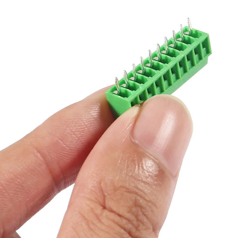 Hand holding a green 10 Pack 10Pin 2.54mm 0.1 Inch Pitch PCB Screw Terminal Block Connectors 150V 6A For 26 To 18 AWG Cable ABS Plastic Housing