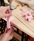 Person using 2 Pack Pink Zipper Jig Tool For Zipper Pulls Plastic Zip Slider Installing Tool Adjustable Handy Zip Fastener Jig
