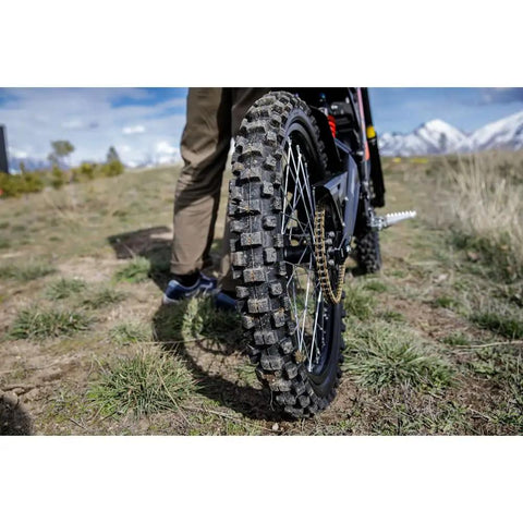 Rear Electric Dirt Bike Tire 80/90x19 Tube Type Fits Surron And Segway Talaria showing tread design and grip on uneven terrain.