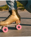 Roller skate with pink wheels from 4 Pack Roller Skate Wheels With Bearings Double Row Outdoor Quad Skating Wheels Semi Jelly PU Material Replacement Parts For Roller Skates For Recreational Use. On sidewalk. Focus on wheels.