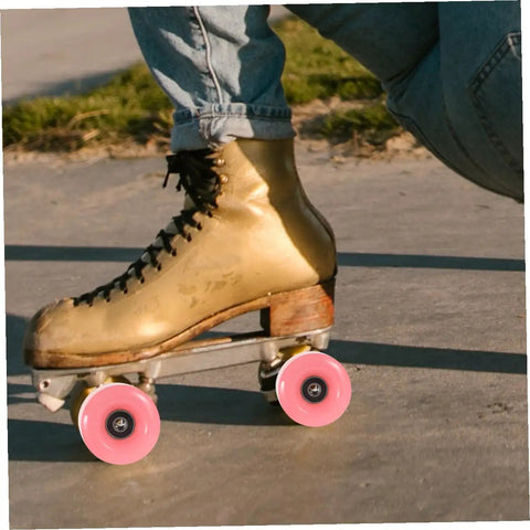 Roller skate with pink wheels from 4 Pack Roller Skate Wheels With Bearings Double Row Outdoor Quad Skating Wheels Semi Jelly PU Material Replacement Parts For Roller Skates For Recreational Use. On sidewalk. Focus on wheels.