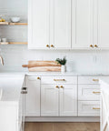 Modern kitchen with white cabinets featuring Six Pack Antique Brass Cabinet Pulls and Drawer Handles, Six Point Three Inch Center To Center, Vintage Bronze Zinc Alloy Bar Pulls for Furniture, Cupboards, and Kitchen Cabinets, Retro Style Hardware for Effortless Upgrades.