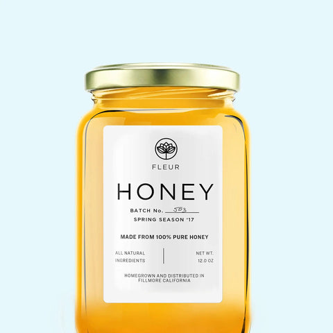 Fleur 12 oz jar of honey with label indicating 100% pure honey, batch No. 503, Spring Season '17, all natural ingredients.