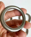 Hand holding Stainless Steel O Rings 5 Pack Heavy Duty Seamless Welded Closed 1.6 Inch Outer Diameter 42mm Inner 30mm 6mm