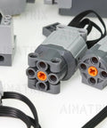 9-Piece Building Blocks Motor Kit With M And L Motors, Battery Box, Remote Control And Speed Adjust, Powers Multiple Motors For Complex Moving Models, Compatible With Major Toy Brick Brands. Close-up of gray brick motors with orange connectors and cables