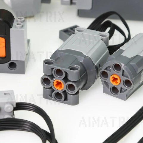 9-Piece Building Blocks Motor Kit With M And L Motors, Battery Box, Remote Control And Speed Adjust, Powers Multiple Motors For Complex Moving Models, Compatible With Major Toy Brick Brands. Close-up of gray brick motors with orange connectors and cables
