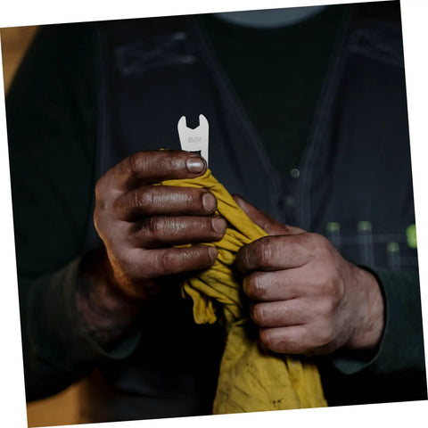 Hands holding an 8mm wrench and a yellow cloth featuring the Dead Accurate Open Head Torque Wrench For Road Bike Hydraulic Oil Disc Brake Systems.