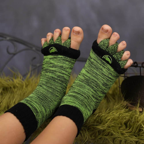 Close-up of feet wearing Foot Alignment Socks With Toe Separators For Men And Women, green and black color; breathable design.