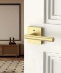 Gold Privacy Door Handle Set With Keyless Interior Button on white bedroom door, brushed gold modern lever and knob.