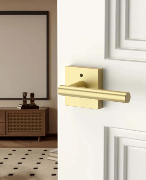 Gold Privacy Door Handle Set With Keyless Interior Button on white bedroom door, brushed gold modern lever and knob.