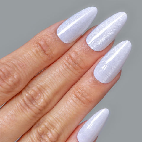 Close-up of a hand with white glossy nails applied with Pro Quick Dry Nail Glue For False Nails And Tips That Delivers A Strong Hold