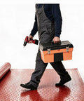 Person walking on Heavy Duty Insulating Rubber Electrical Safety Mat Built Like A Tank For Real Deal High Voltage Protection and Slip Resistant Flooring, carrying toolbox and drill.