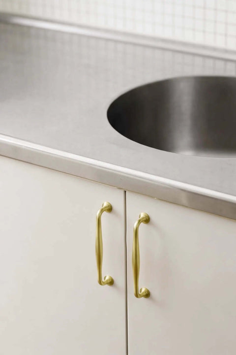 Brushed Gold Cabinet Pulls 5 Inch Hole Center 6 Pack Zinc Alloy Handles on white kitchen cabinets with stainless steel countertop.