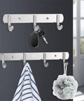 Total Game Changer Wall Mount Coat Rack Flip Down Swivel Hooks Sculptural Polypropylene Art For Bathroom Kitchen Durable Rock Solid Robe Hook Clothes Hat Bag Heavy Duty Organizer with keys and towel displayed.