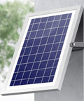 Hella Bright 200 Watt Solar Flood Light With Integrated Remote And Badass IP67 Waterproof Shell solar panel mounted on wall.