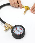 Fuel pressure test kit with brass fittings and 0-100 PSI gauge on a black hose.