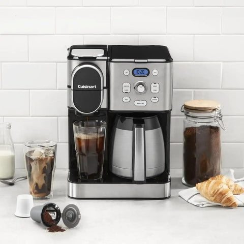 Two In One Coffee Maker With Ten Cup Thermal Carafe And Single Serve Brewer With Over Ice Function Fully Automatic Pod And K Cup Compatible For Four To Twelve Oz Brews Black And Stainless Finish shown with coffee accessories on a counter.
