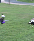 Person using R8SM 2.4 GHz 8 Channel Mini Receiver For FPV Drones With SBUS PPM Long Range Control Ultra Tiny Size FHSS Anti Interference Technology Compatible With T8FB T8S Transmitters outdoors