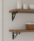 Wooden shelf with ornaments supported by Carbon Steel L-Shaped Shelf Bracket Heavy Duty Wall Mount Support For Floating Shelves.